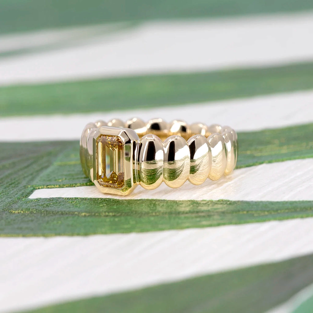 Bena Jewelry’s yellow diamond gold ring worn on a hand, showing its bold, bubbly design and rich golden tones.