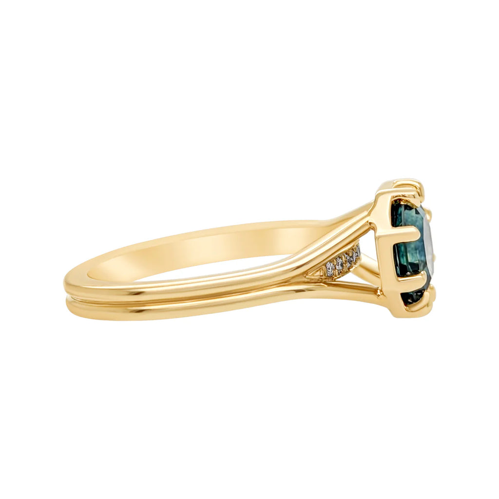 Side view of the Arden ring by Emily Gill, featuring a split shank band in 14k yellow gold, with an octagonal Montana sapphire and diamond accents. Contemporary designer engagement ring available at Ruby Mardi, Montreal.
