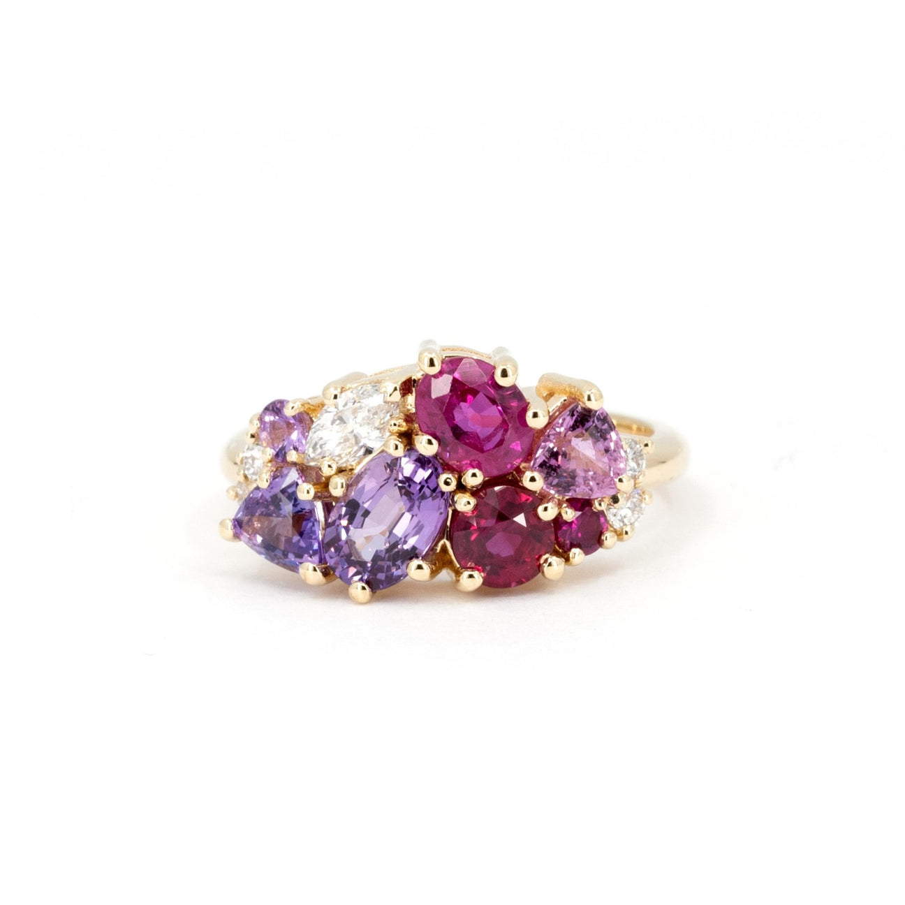 Cluster gemstone ring with stones in the shades of purple, dark pink and mauve, as well as diamonds. We can custom make a ring like that for you too!
