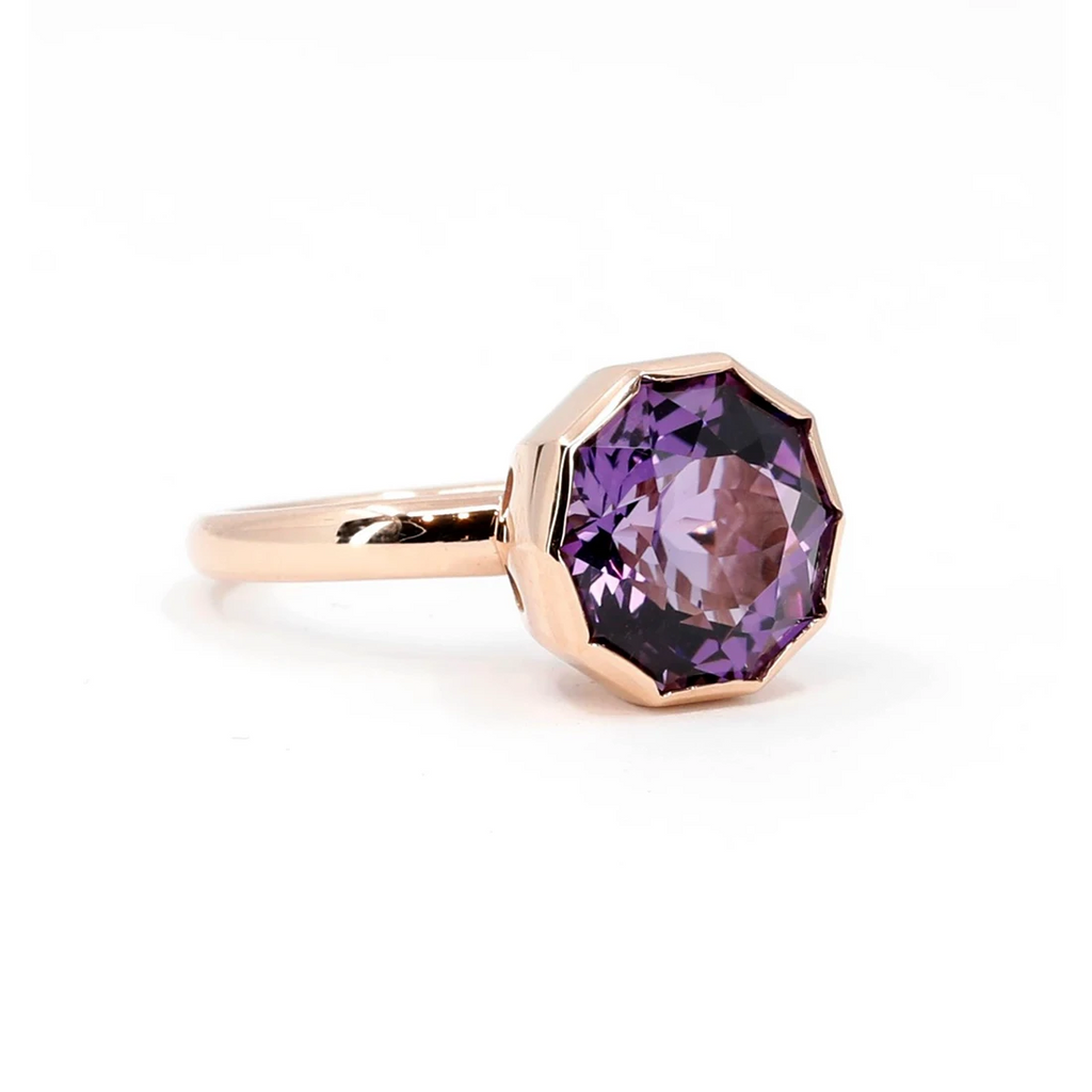 Designer cocktail ring in rose gold with a big round fancy shape amethyst, seen on a white background. This ring was designed by Bena Jewelry and is available at Ruby Mardi, the funkiest jewelry store in Canada.