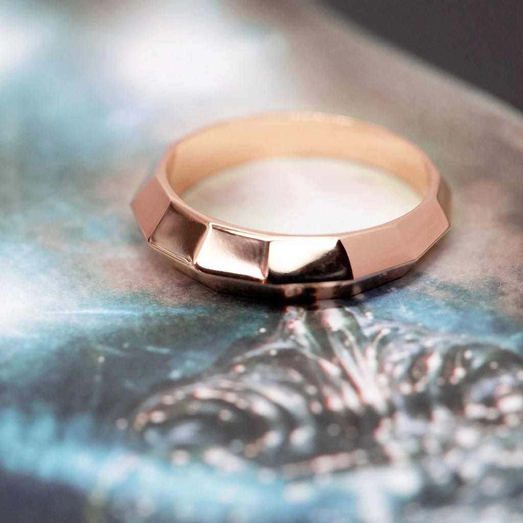 This edgy men's band is a timeless wedding ring and made by the fine jewelry store Ruby Mardi by a local artisan jeweler working ethically. The men's wedding ring is made in rose gold with a contemporary edgy touch making it an alternative wedding jewelry and made in Canada by independent jewelers.