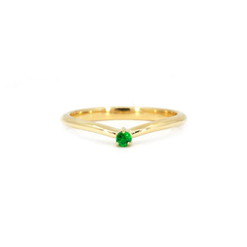 A minimalist yellow gold curved band with a vibrant green garnet centerpiece, showcasing sleek lines and modern design. The ring is photographed on a white background to emphasize its clean and elegant aesthetic.