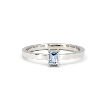Minimalist white gold ring featuring a light blue sapphire baguette set horizontally. A sleek and modern design by Ruby Mardi in Montreal.