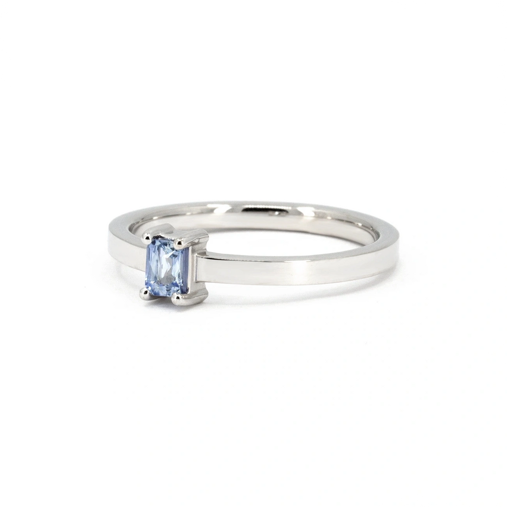 Sleek white gold ring featuring a horizontally set light blue sapphire baguette photographed on a white background. A refined and modern design by Ruby Mardi, crafted in Montreal.