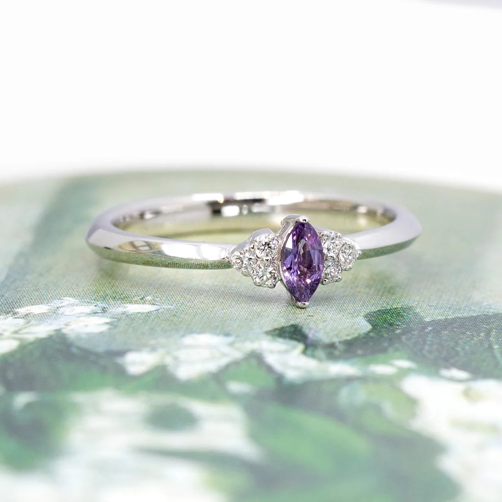 This engagement ring made in Canada is a one-of-a-kind creation. This marquise-shaped purple sapphire is set with small natural diamonds. Made with white gold, this bridal ring is made by Ruby Mardi the best jewelry store in Montreal.