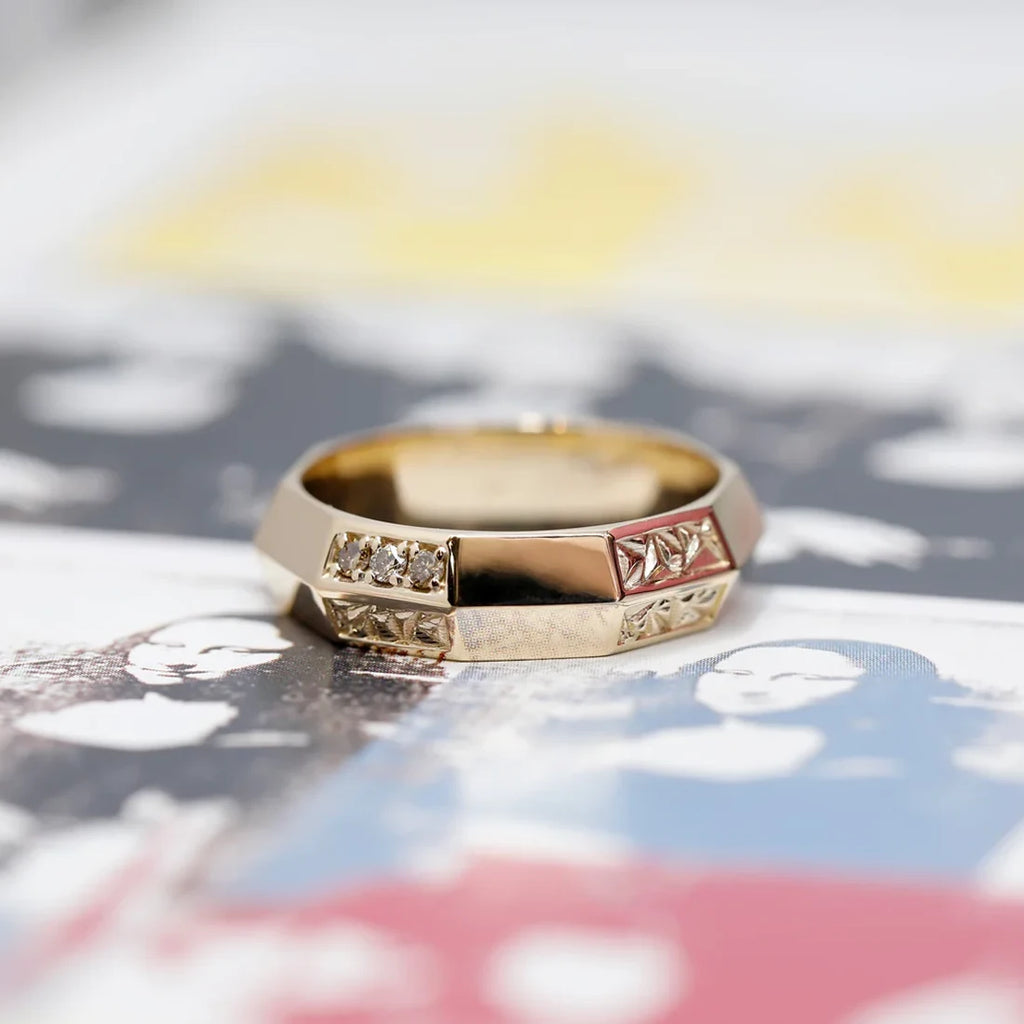 A classic and modern man wedding band is seen photographed on a Wharol Mona Lisa piece of art.