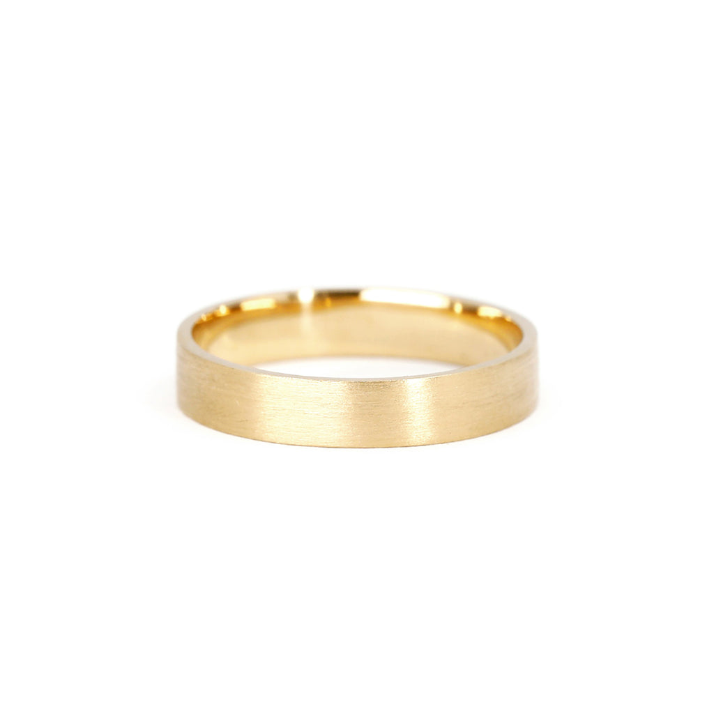 This wedding band is made in yellow gold in Montreal by Ruby Mardi jewelry, a specialist in classic and alternative bridal jewelry. The finish of this ring is matte to have an elegant and timeless effect. Custom made in Canada by independent jewelry artisans.