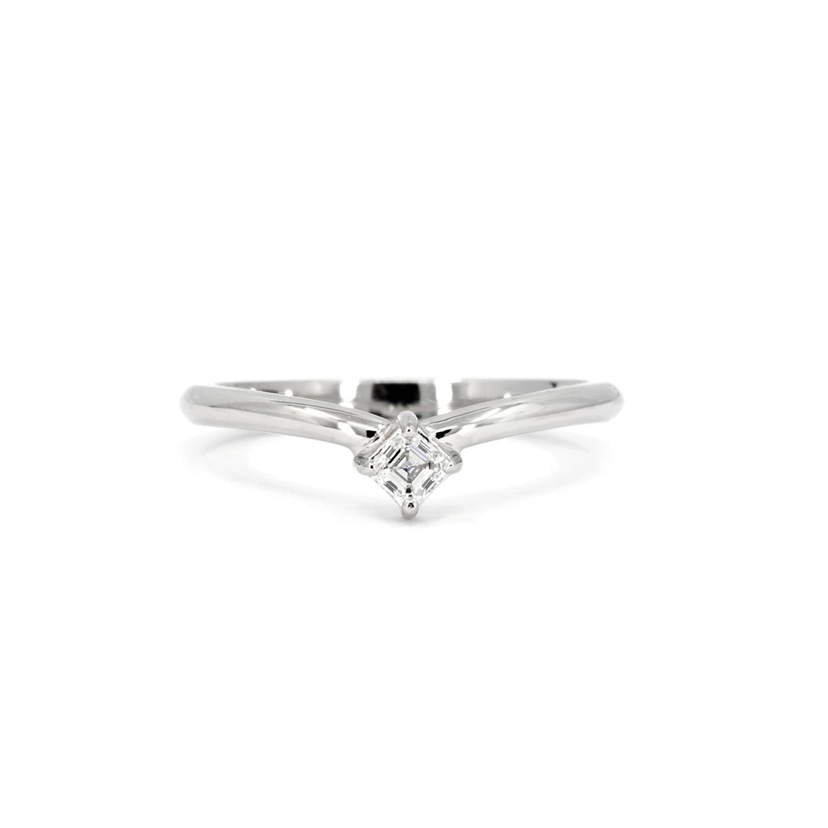A sleek white gold ring featuring an Asscher-cut diamond set in a delicate V-shaped band. The minimalist design emphasizes clean lines and symmetry, making it perfect for stacking or as a modern engagement ring. Designed and crafted by Ruby Mardi in Montreal, this refined piece is photographed against a crisp white background to highlight its brilliance and polished finish.