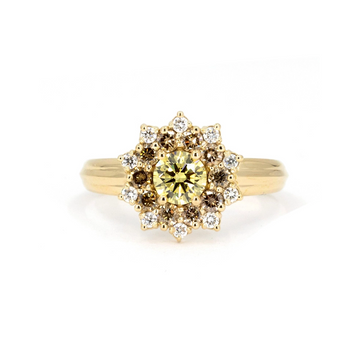 Product photo of a sun-shaped ring on a white background. The ring features a wide yellow gold band and a central round yellow laboratory diamond, surrounded by round gold/brown diamonds and white diamonds. This unique engagement ring is a creation by designer Bena Jewelry.