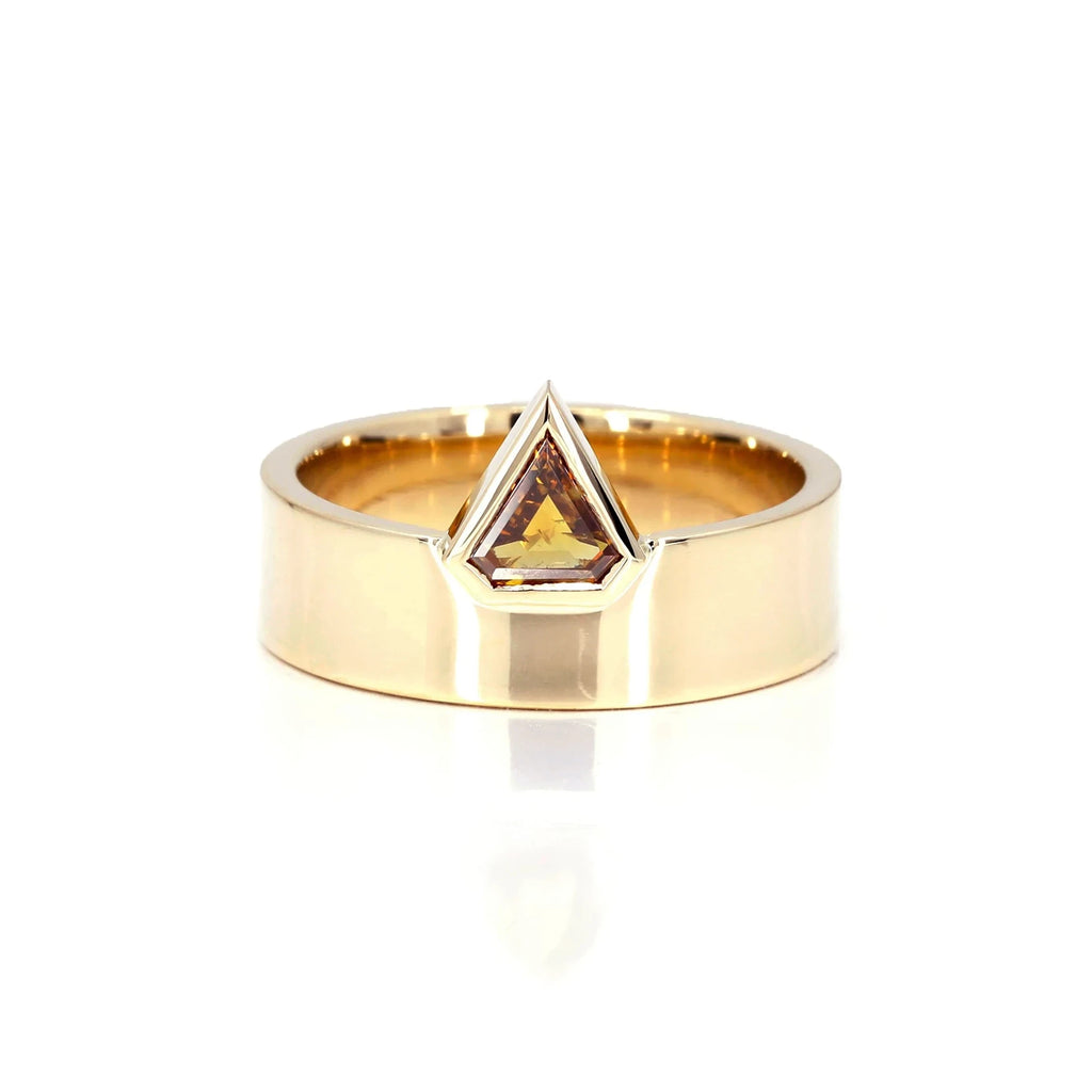 This edgy and unique ring is made by independent jewelry designer Bena Jewelry made in Canada. Made in yellow gold with a natural orange/honey colored diamond, this unisex and guaranteed piece of jewelry can be purchased as an alternative engagement ring or a statement ring to wear for all occasions. This fine piece of jewelry is available for sale at the Ruby Mardi jewelry store in Montreal.