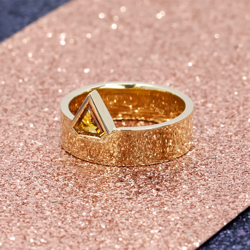 Splendid alternative engagement ring, this fine jewelry is custom-made in Montreal in collaboration with the most beautiful jewelry store in Montreal Ruby Mardi, specializing in fine jewelry from independent Canadian designers. This yellow gold ring has a fancy triangle brown orange diamond.