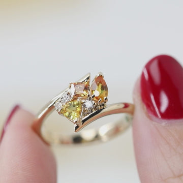 Video showcasing Ruby Mardi's ‘Avalanche Kink’ ring in 14k gold, featuring orange sapphires and diamonds. The video shows a close-up of the ring, highlighting its bold design, and also displays it worn on a finger for a better sense of scale and style.