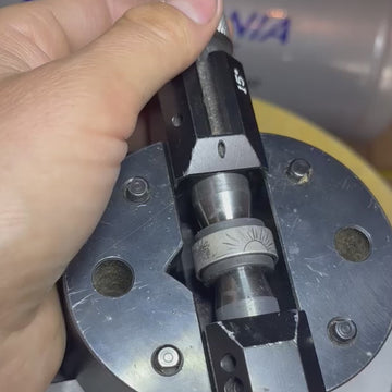 Video showing a white gold wedding band by Rebel & Rogue with floral motifs sketched in pencil before engraving. The ring is secured on a jeweller’s engraving block at the workbench, offering a behind-the-scenes look at the hand-engraving process and the artist’s detailed preparation work.