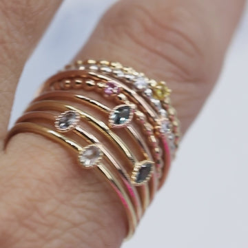 Rings from Montreal jewelry designer Émigé presenting several of her models in gold with small diamond stones and rose cut sapphires. Jewelry available at the Ruby Mardi jewelry store located in Montreal.