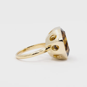 An animated view in 360 of a huge natural citrine cocktail ring bezel set in yellow gold. The ring has oval openings on eight facets. It's a creation from designer Bena Jewelry, a Canadian independent brand.