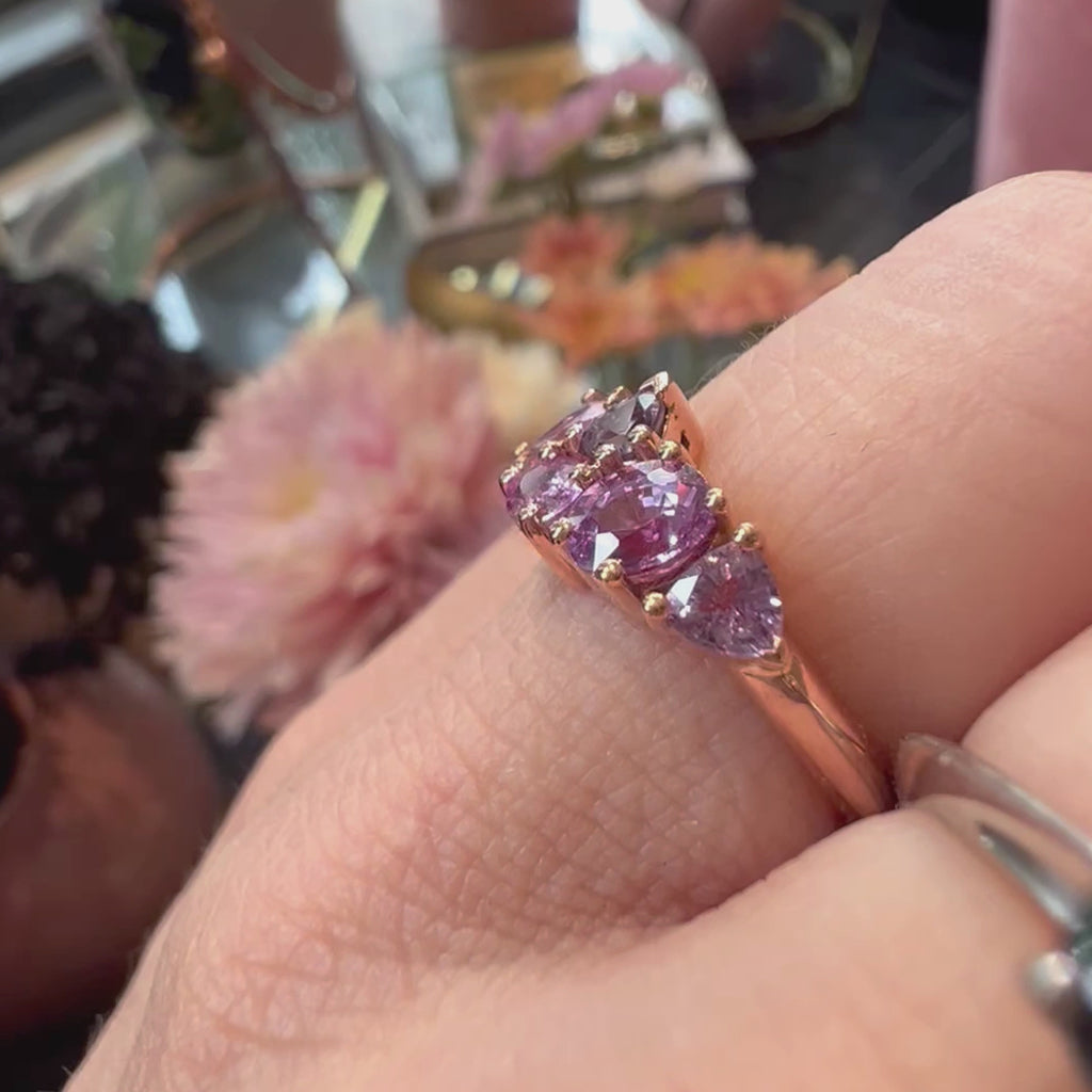 A video with a soundtrack from the B-52's is showing a hand wearing an all purple sapphire designer engagement ring. It's filmed at jewelry store Ruby Mardi, in Montreal's little Italy.