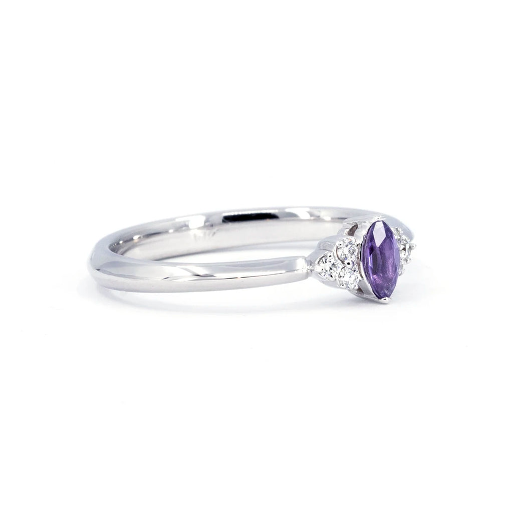 The Ruby Mardi jewelry store, specialist in Canada for wedding rings with natural colored gems, presents this engagement ring with a purple sapphire and maquise shape, composed of small diamonds, this wedding ring is available for sale in store or online.