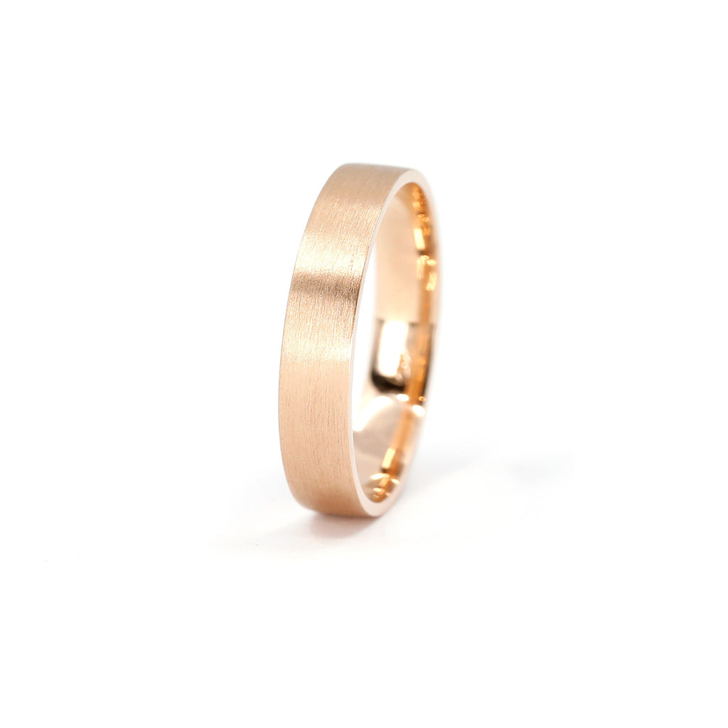Classic 4mm wedding band in rose gold with a satin finish seen photographed on a white background.