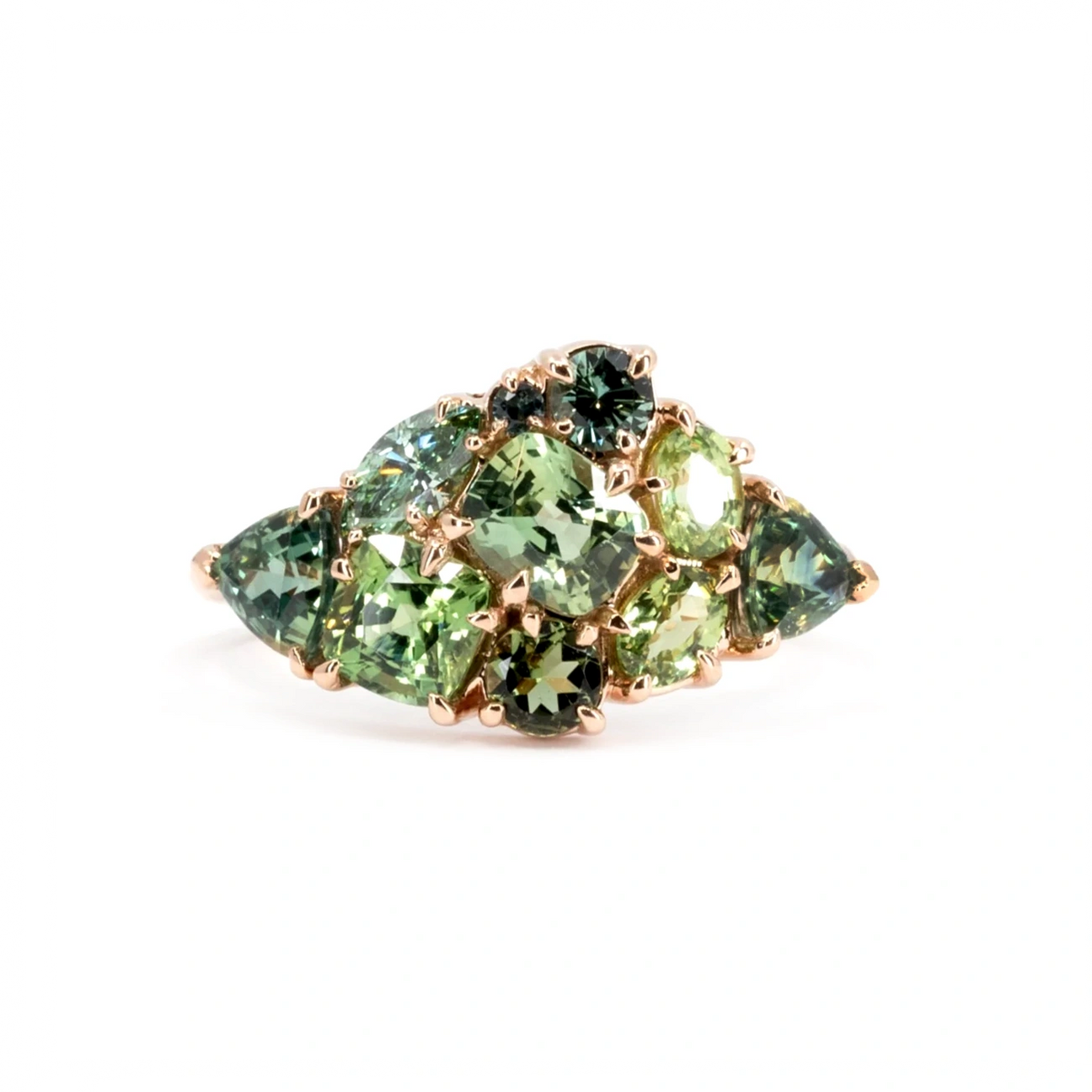 Bold Avalanche ring in 14k rose gold featuring a stunning cluster of green gemstones, including sapphires, garnets and teal diamonds. A statement piece handcrafted by Ruby Mardi in Montreal.