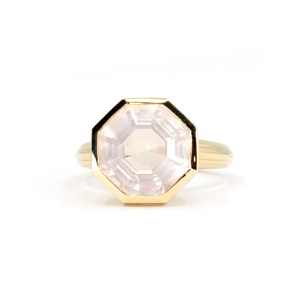 Big rose quartz cocktail ring photographed on a white background. The ring has an octogonal shape and is bezel set in yellow gold. It's a creation from independent jewellery designer Bena Jewelry.