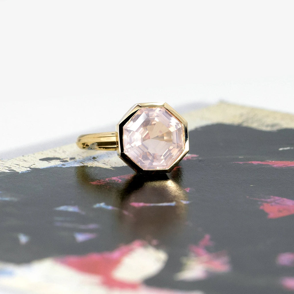 Big yellow gold rose quartz cocktail ring photographed on an abstract background. The ring of an octogonal shape is bold and stunning. It's a creation from Bena Jewelry and it's available at independent Canadian jewelry store Ruby Mardi.