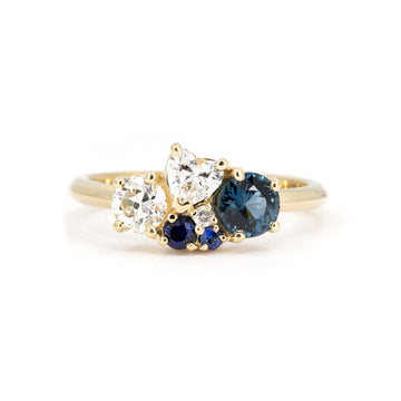 Elegant custom-made ring by Ruby Mardi, featuring a stunning cluster of blue spinel, sapphires, and diamonds, set in yellow gold. Handcrafted in Montreal.