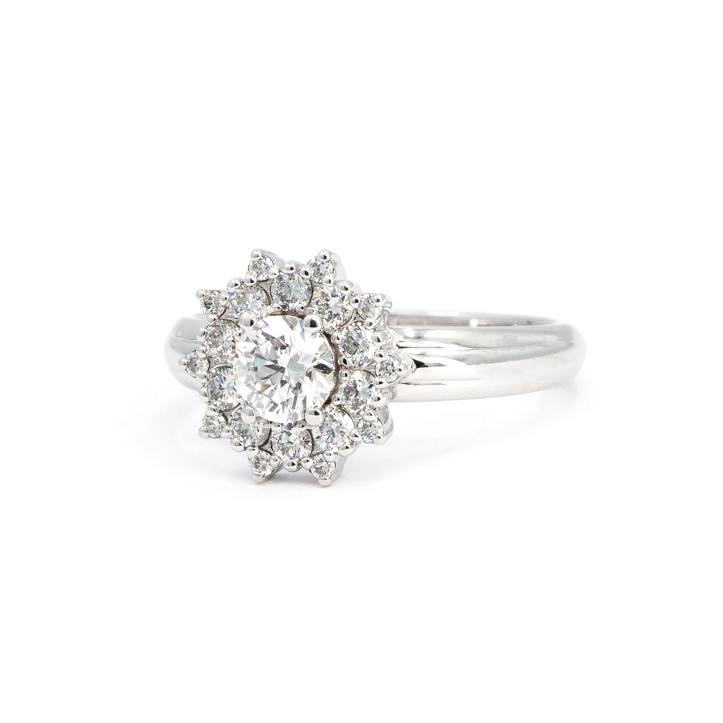 White gold engagement ring with round diamond center and intricate double halo of pavé-set diamonds. Handmade by Bena Jewelry in Montreal, Canada. Available at Ruby Mardi.