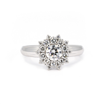 White gold diamond engagement ring with floral double halo design, featuring a brilliant-cut central diamond and pavé accents. Contemporary fine jewelry by Bena Jewelry, made in Montreal, Canada. Available at Ruby Mardi.