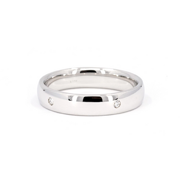 Classic wedding band for men in white gold with the addiction of small lab grown diamonds on the exterior. This canadian jewelry piece was handcrafted in Montreal by local independent jewelry store Ruby Mardi, that sells canadian jewelry and designer pieces.