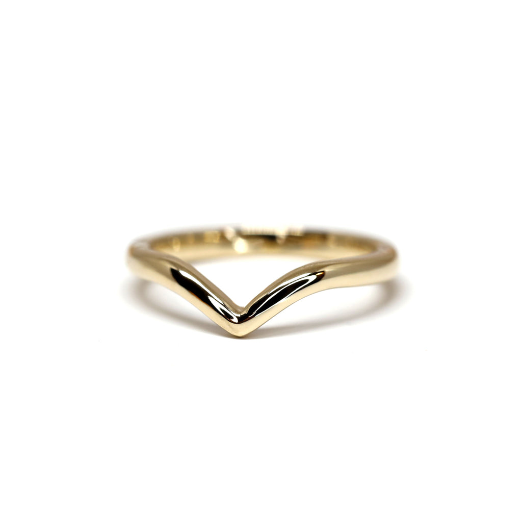 Simple 14k yellow gold crown wedding band on a white background.