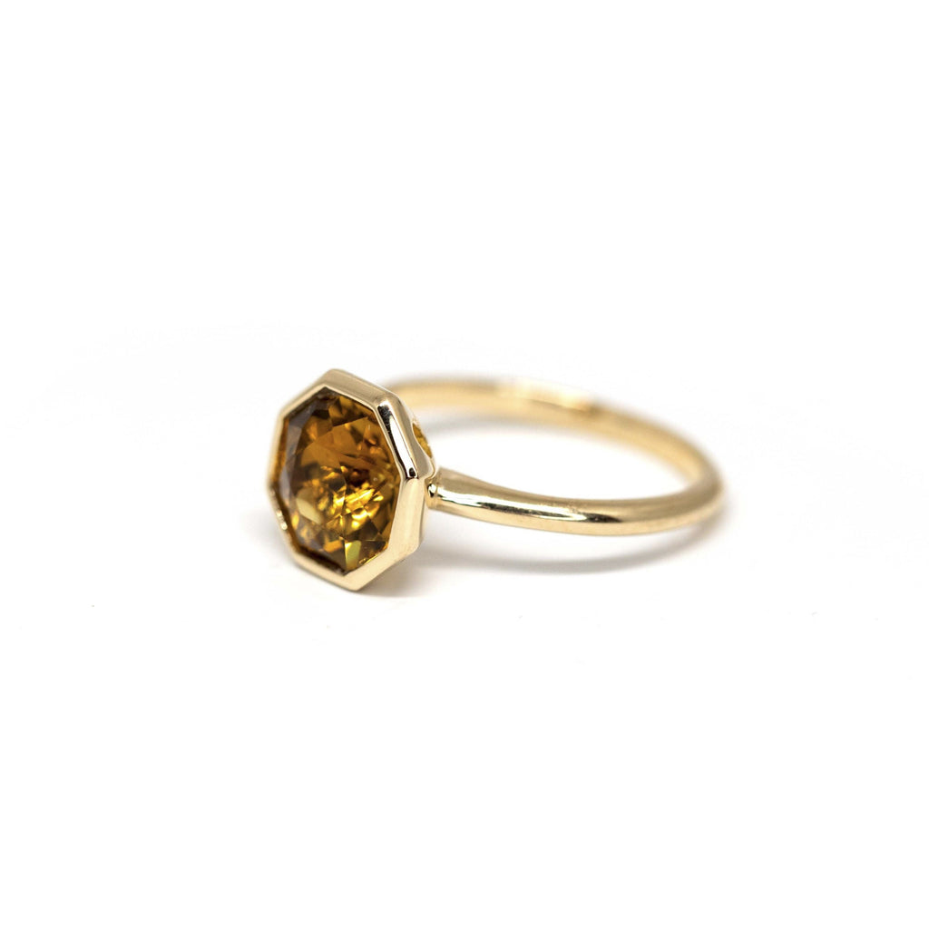 side view of fancy shape colored gemstone citrine yellow gold bezel setting ring custom made in the best jewelry store in montreal boutique ruby mardi on white background
