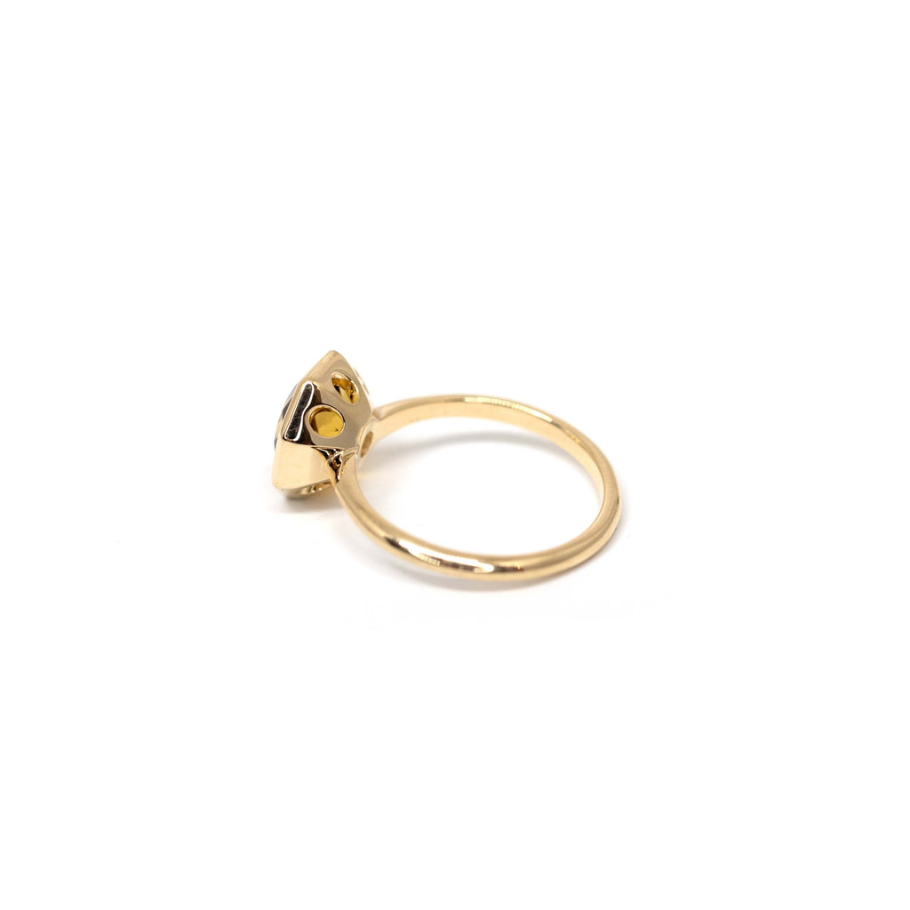 back view of yellow gold custom made citrine ring in montreal at boutique ruby mardi fine jewelry gallery of canadian jewellery designer on white background
