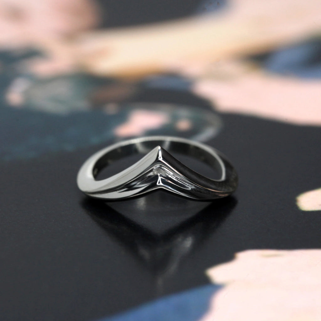 unisex edgy silver adron ring on a black background