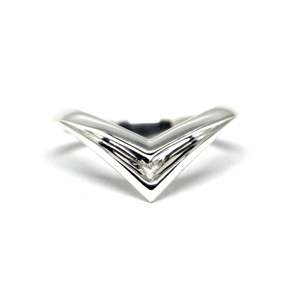 Curved design edgy silver ring made by bena jewelry on a with background
