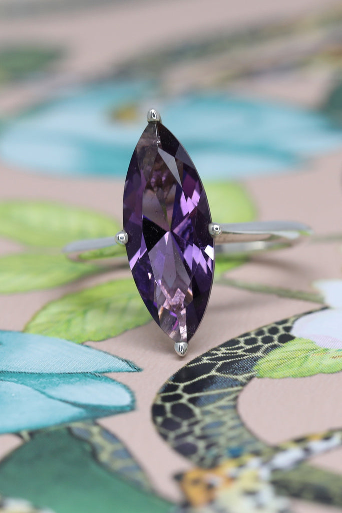A ring from designer Bena Jewelry seen on a wallpaper. A statement ring featuring a big marquise amethyst set in sterling silver. Fine jewelry handmade in Montreal and available online for worldwide shipping. 