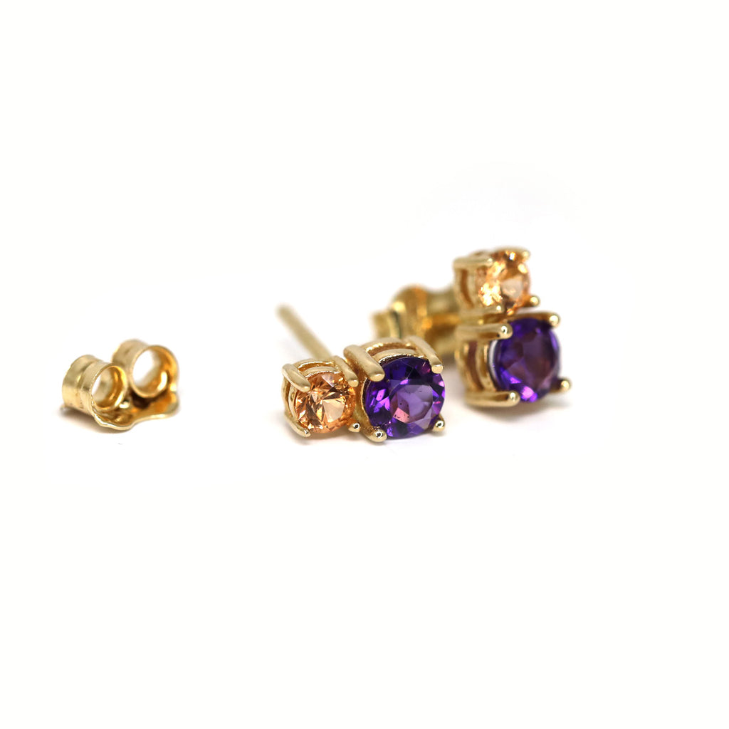 Gold gemstone stud earrings featuring orange garnet and amethyst. Jewelry available at fine jewellery store gallery Ruby Mardi, located in Montreal’s Little Italy.