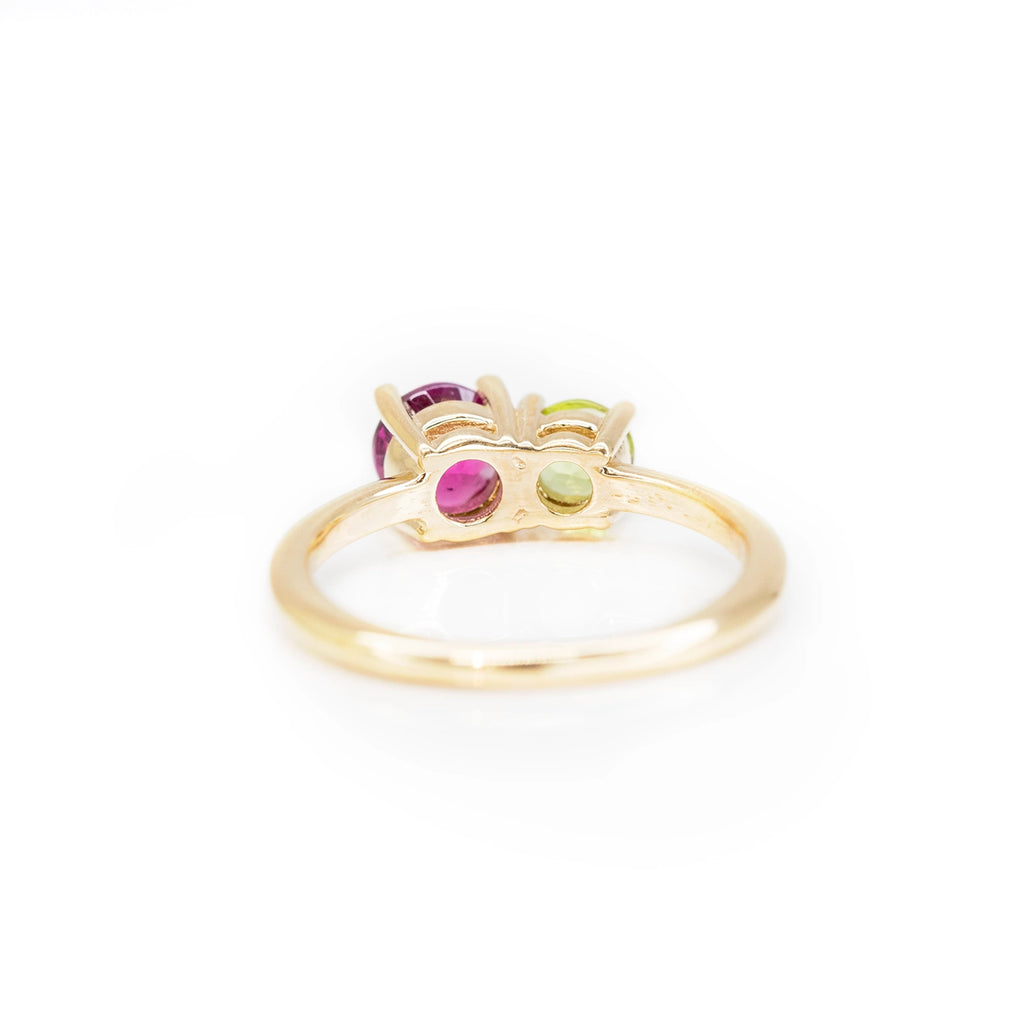 back view of yellow gold colored gemstone custom made bridal ring in montreal at the best jewelry store in quebec with fine jewellery designers on pink background