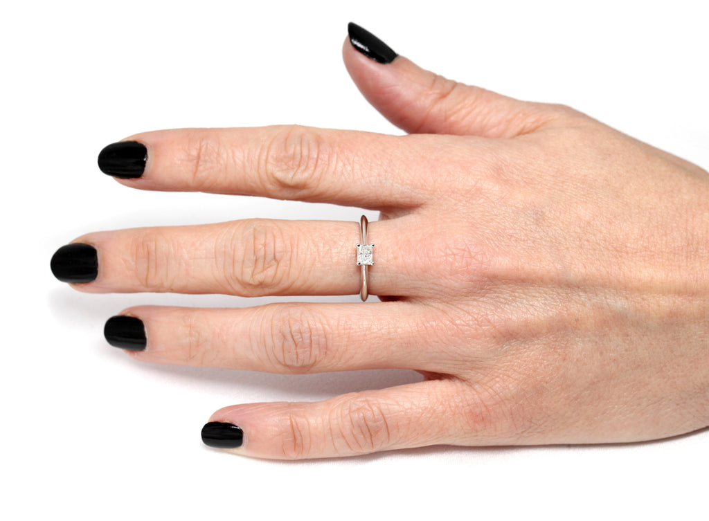 girl hand wearing a custom made diamond engagement ring custom made by ruby mardi finest jewellery designer and jeweler in montreal little italy on a white background