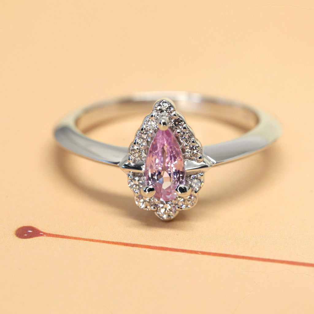 pink sapphire diamond engagement ring custom made in montreal by the jeweller ruby mardi on a yellow background