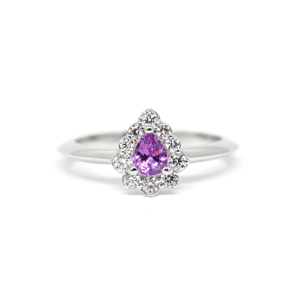 Pear Shape Purple Pinkish Sapphire Engagement ring with a diamond halo by Ruby Mardi, a fine jewelry gallery in Montreal Little Italy. White gold gemstone ring, bridal jewelry, wedding ring, ethical gem. Ruby Mardi offers custom jewelry services in Montreal. Lab grown diamonds, natural diamonds, Canadian diamonds, ethical diamonds, ethical gemstones.