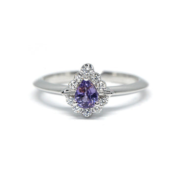 pear shape purple sapphire with a diamond halo white gold custom made engagement ring in montreal by ruby mardi jeweller in little italy on a white background