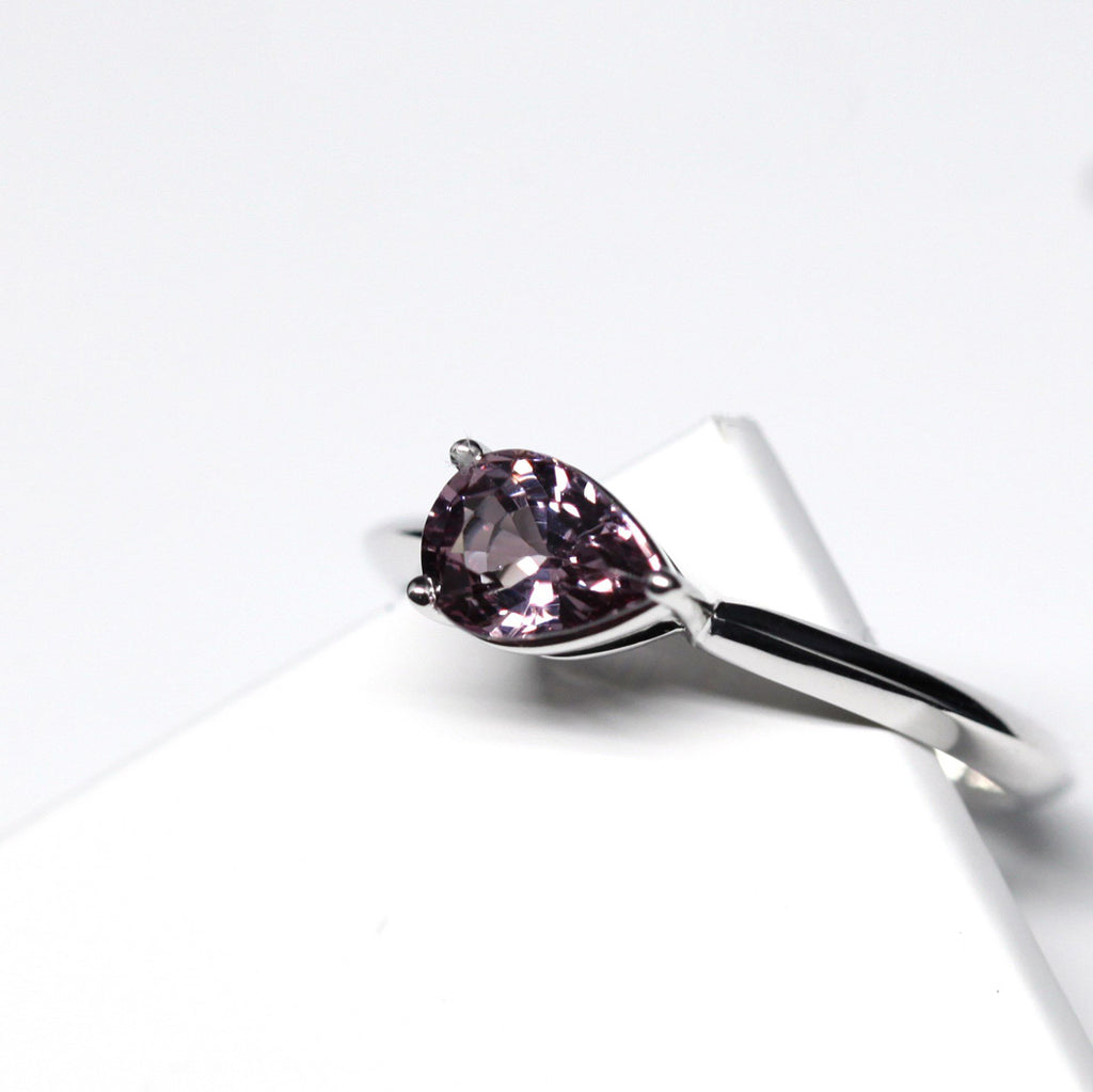 side view pear shape malaya garnet custom made colored gemstone engagement ring in montreal on a white background