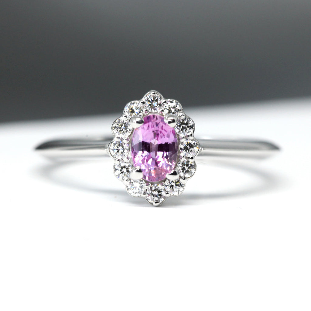 front view of oval shape pink sapphire diamond halo custom made white gold bridal ring by ruby mardi jewellery designer in montreal