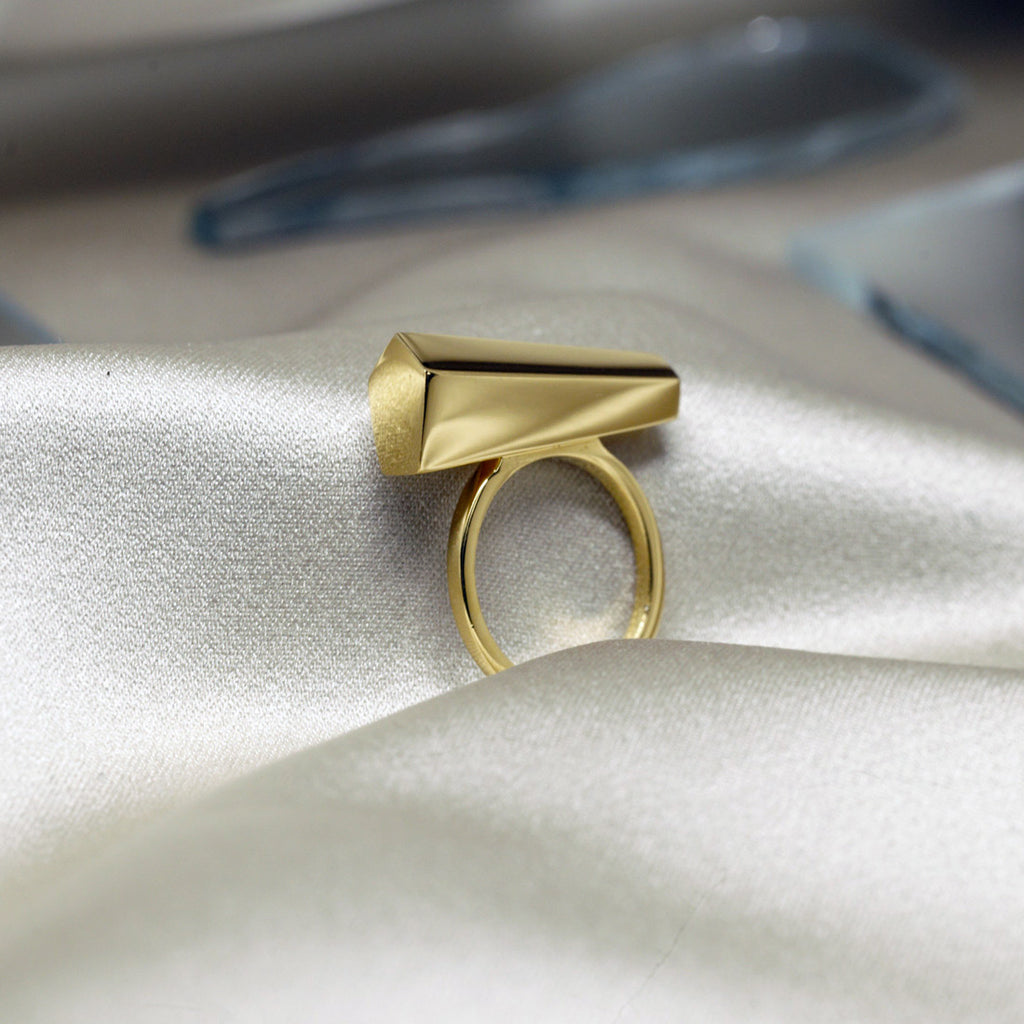 Canadian jewelry designer Bena Jewelry's vermeil Sturdy ring, photographed in close-up on a satin fabric. Modern and predominantly handcrafted jewelry available at Ruby Mardi, online or in Montreal's Little Italy.