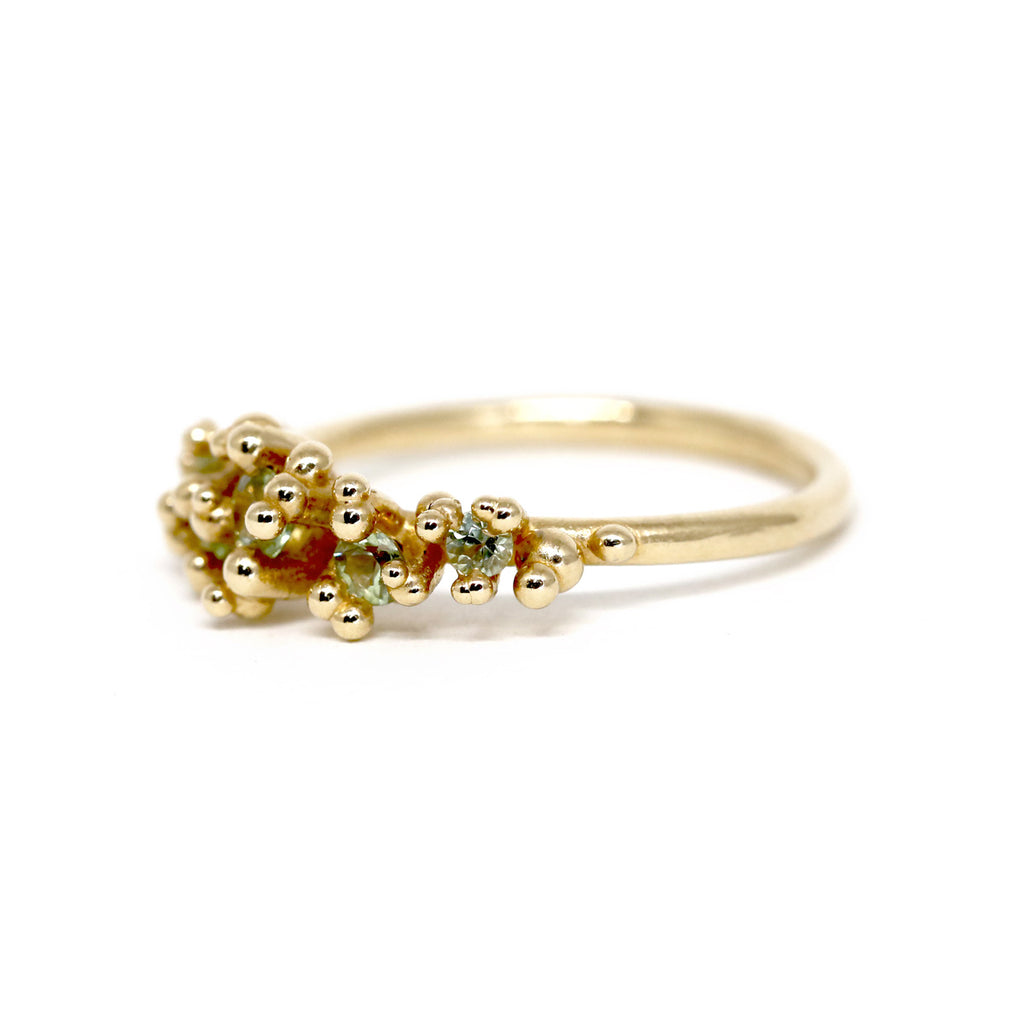 side view of a yellow gold green sapphire custom made bridal engagement ring montreal made fine jewelry desginer ruby mardi
