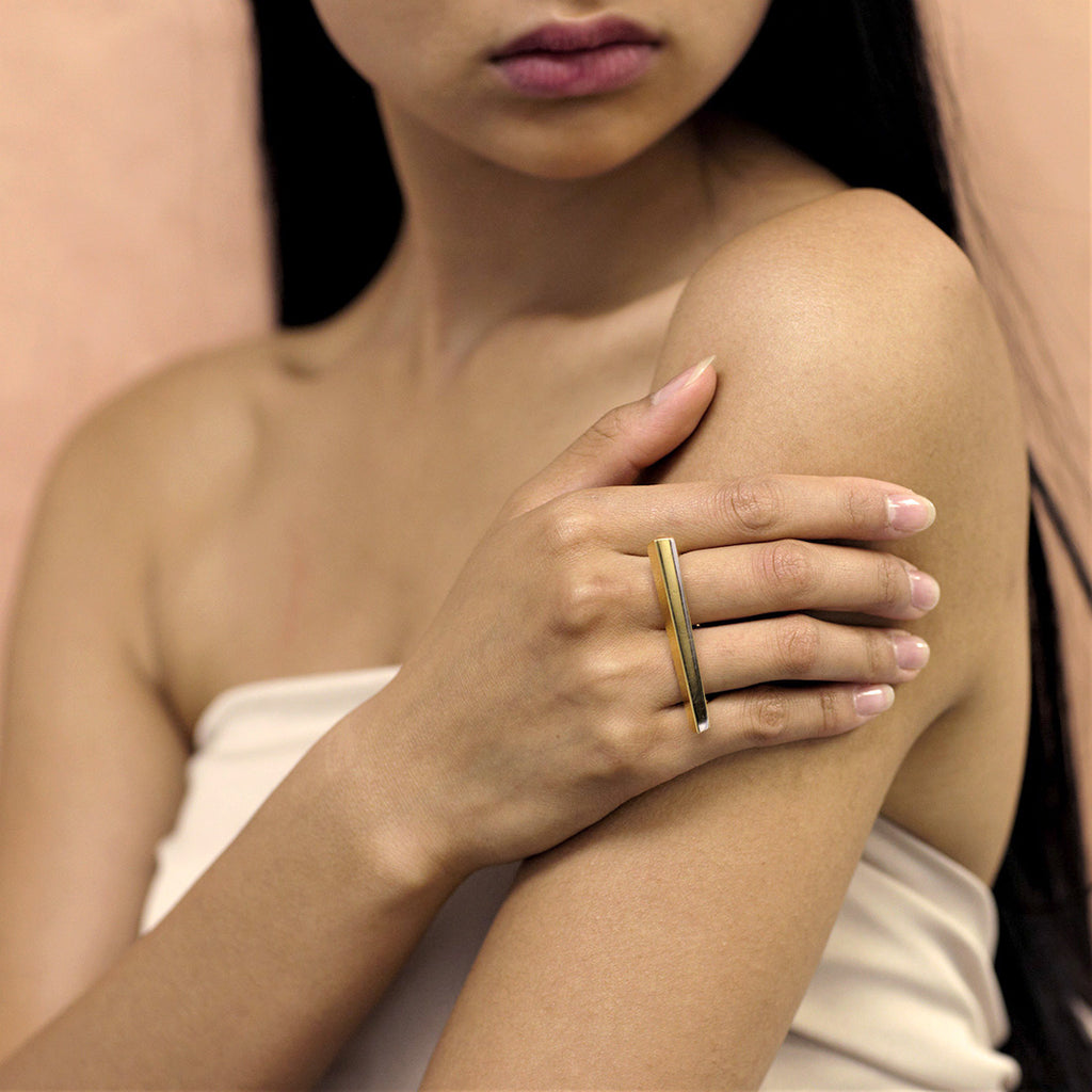 Fashion shot of PUNCH RING, a modern statement gold vermeil ring also available in sterling silver and solid gold. Fine jewelry handmade in Montreal and available online for worldwide shipping.