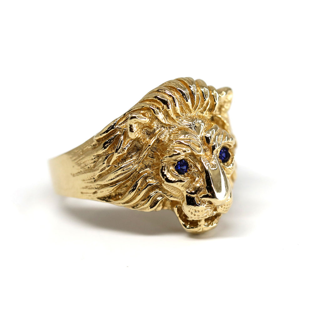 Shot on a white background : Gold lion head ring with blue sapphire eyes by jewellery designer Cecilia Lico. Her creations are available at Ruby Mardi, a high end store located in Montreal's Little Italy.