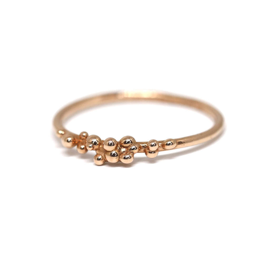 Rose gold Areia delicate ring on a white background by Toronto-based jewelry designer Meg Lizabet. Organic ring with hand-placed gold granules. 14K rose gold ring, original wedding band or engagement ring. Unique ring that cannot be reproduced. Find Meg Lizabet's creations in Montreal at Ruby Mardi, a boutique-gallery in Montreal's Little Italy, not far from Rosemont, Villeray, Outremont, Mile End. Custom jewelry design services in Montreal also available.