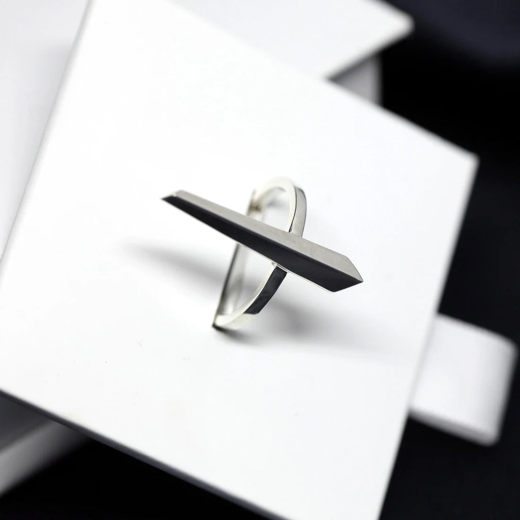 Sturdy ring in sterling silver photographed under different lightnings. A Minimalist, modern and elegant piece of jewelry. Find this gender-neutral ring that fits both classic and edgy wardrobes at Ruby Mardi, online or at our concept-store in Montreal’s Little Italy.