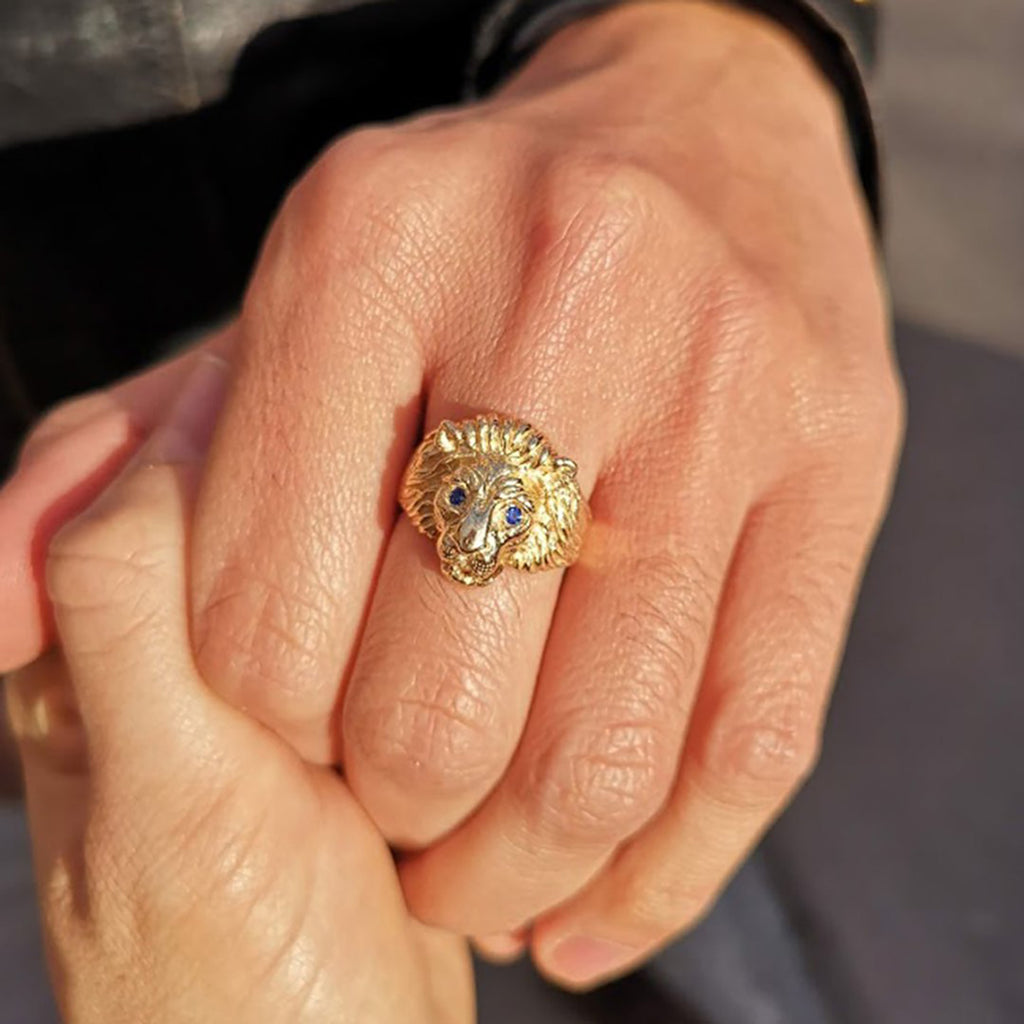 Gold lion head ring with blue sapphire eyes by jewellery designer Cecilia Lico. Her creations are available at Ruby Mardi, a luxury jewellery store located in Montreal's Little Italy.